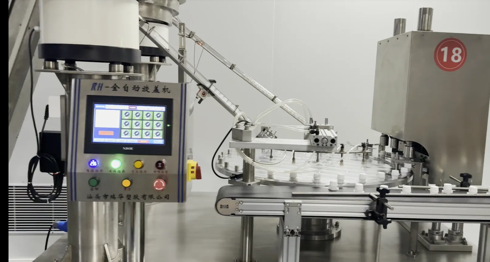 A rotary capping machine with white spout caps fed and oriented on its turntable in the factory