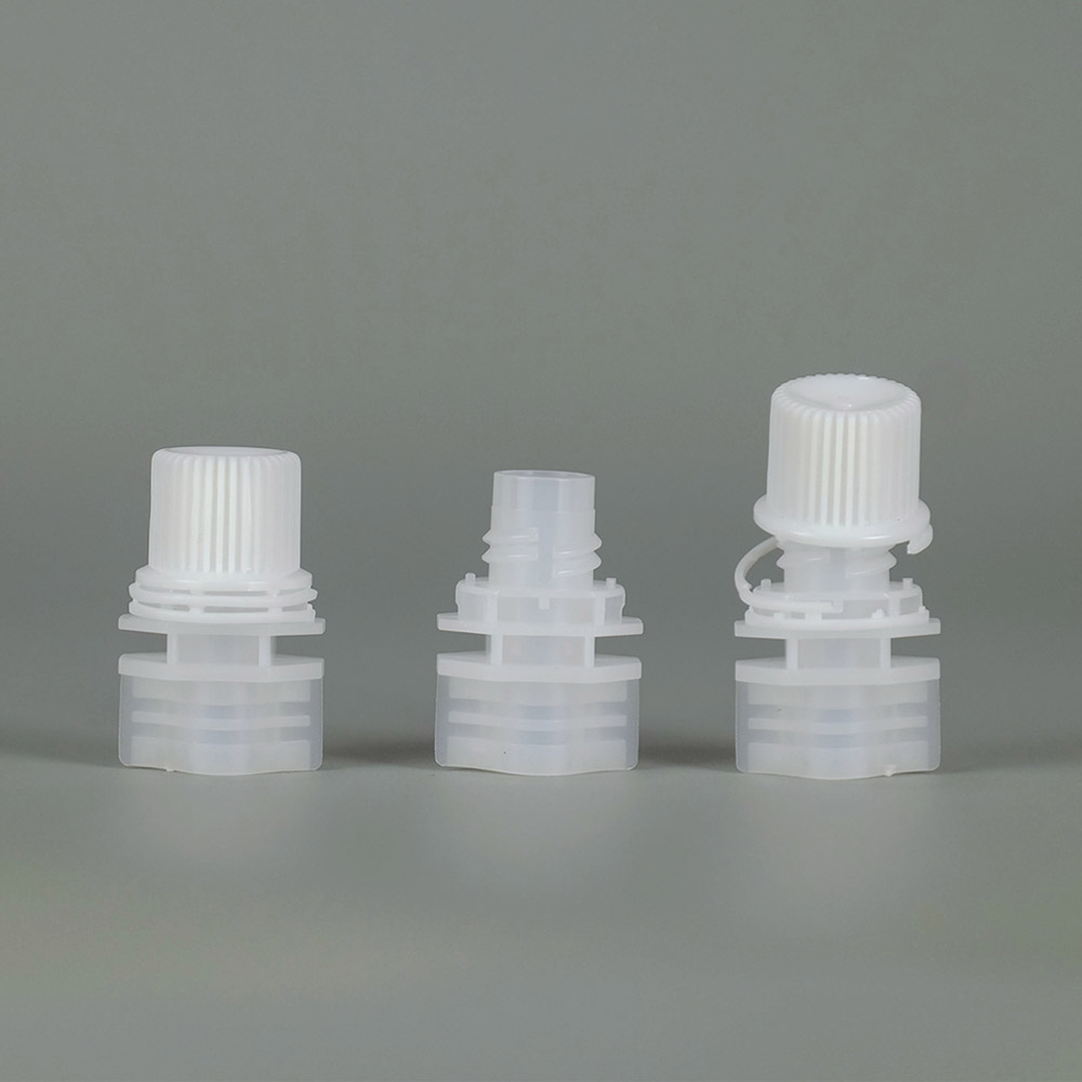 Tethered non-separated twist spout cap for EU baby puree and juice pouches, cap attached to spout base